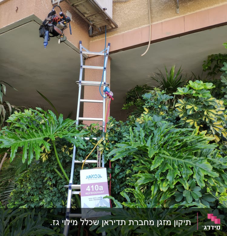 טכנאי מטפס על סולם לתיקון מזגן חיצוני